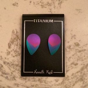 A pair of rain drop shaped earrings.